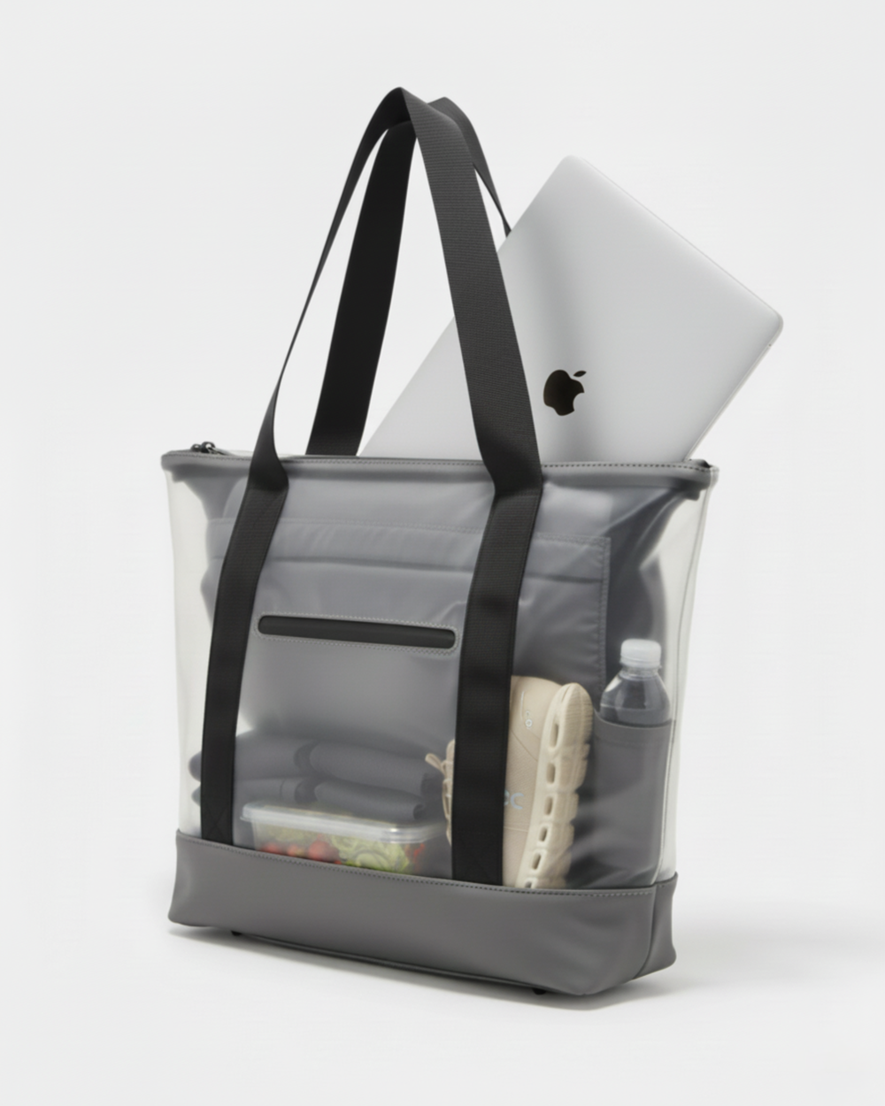 Tote bag transparente con ordenador, zapatillas de deporte, botella, un tupper y ropa de gimansio.